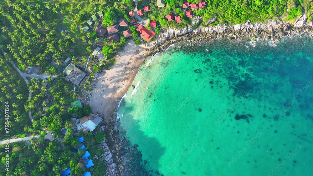 Nestled amidst azure waters, Tao Island is a serene sanctuary boasting lush greenery and pristine beaches. Its tranquil ambiance beckons seekers of inner peace. Aerial view from drone.
