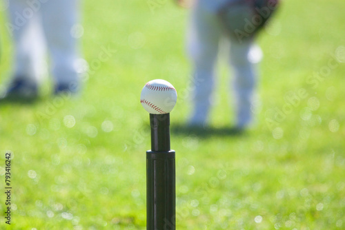 Baseball T ball on Tee, grass background photo