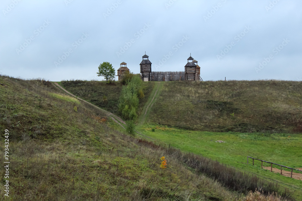 Medieval wooden fortress with towers. Landscape with a view of Pleshcheyevo lake