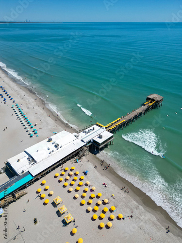 Tourists relaxing near Cocoa Beach pier near Cape Canaveral on Florida's Space Coast
