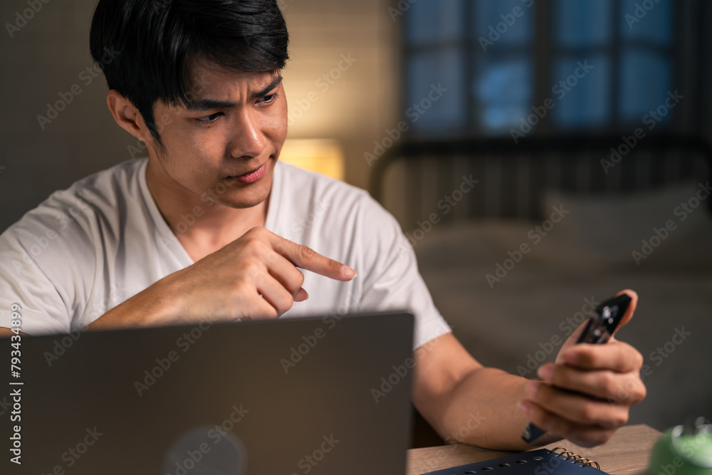 Asian depressed young man overworking alone on working table at night. Asian depressed young man overworking alone on working table at night.