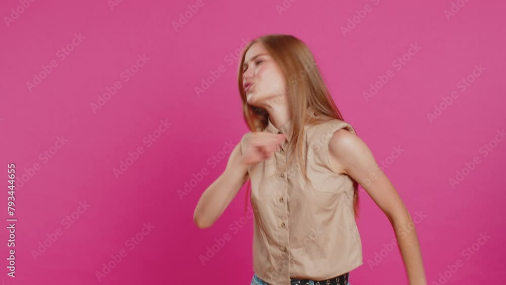 Trendy cheerful positive young woman having fun dancing and moving to rhythm, dabbing raising hands, making dub dance winner gesture. Happy girl isolated alone on pink studio background. Lifestyles Trendy cheerful positive young woman having fun dancing and moving to rhythm, dabbing raising hands, making dub dance winner gesture. Happy girl isolated alone on pink studio background. Lifestyles