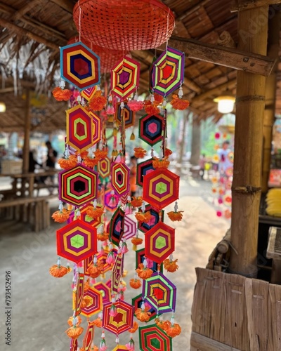 Colorful paper lanterns hanging on the wall of a rural house