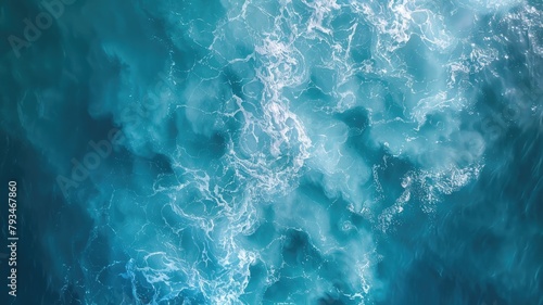 Aerial view of ocean waves creating foam patterns