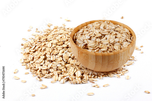 Raw organic oat flakes in wooden bowl on portion of oats isolated on white background. Photography for packaging