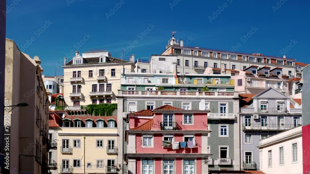 a view of several colorful apartment buildings on a hillside in lisbon, portugal a view of several colorful apartment buildings on a hillside in lisbon, portugal