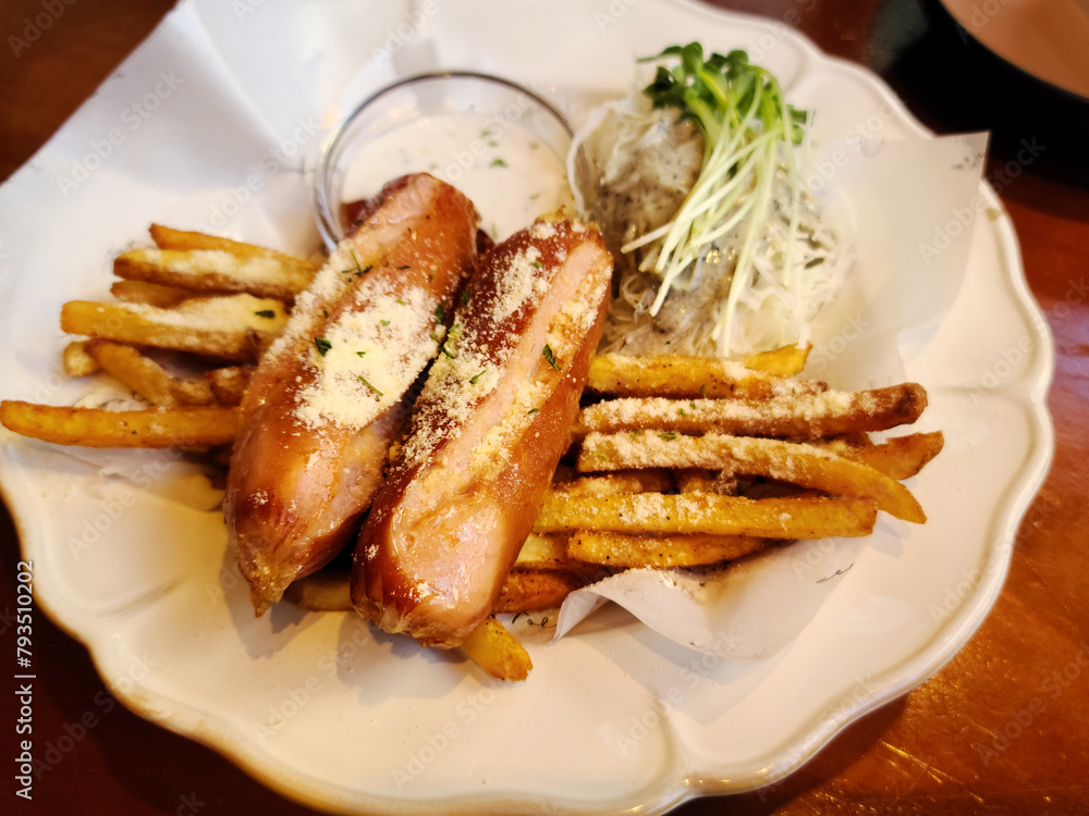 Potato fries and sausages on a plate Potato fries and sausages on a plate