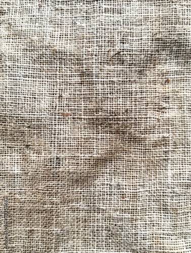 Detailed close-up of rough, tactile woven fabric with grainy surface, showcasing patterns and textures in natural light
