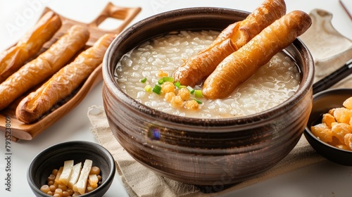 Luxurious Chinese rice porridge, congee, enriched with creamy consistency and served with a choice of fried dough sticks, studio set, isolated background