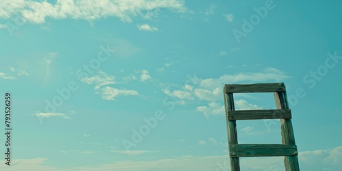 Old wooden ladder standing against a clear blue sky, concept of opportunity.