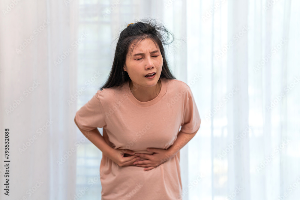 Woman sick unhappy holding belly stomach with suffering from stomach ache pain, monthly period, gastritis, gastroenteritis, food poisoning, diarrhea, intestinal inflammation, Woman healthcare Woman sick unhappy holding belly stomach with suffering from stomach ache pain, monthly period, gastritis, gastroenteritis, food poisoning, diarrhea, intestinal inflammation, Woman healthcare