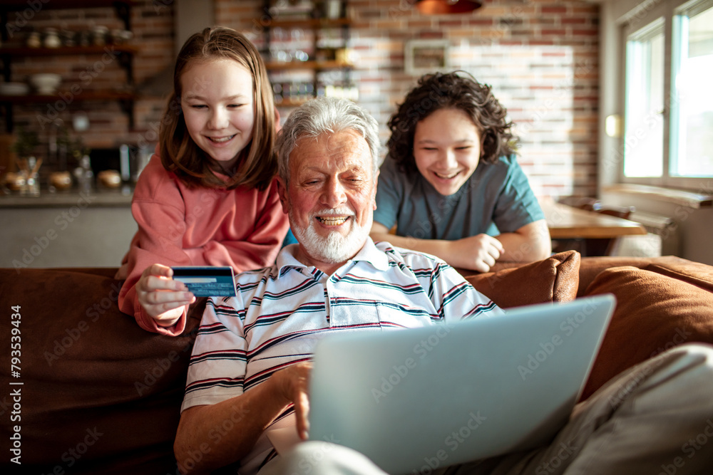 custom made wallpaper toronto digitalGrandfather with grandchildren shopping online using credit card and laptop at home