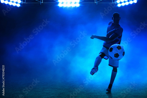 3d illustration shadow silhouette of young professional soccer player kicking ball in empty stadium at night © fotokitas