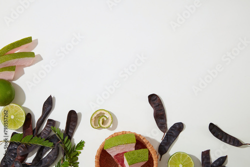 Fresh organic compositions flat lay on white table, lemon, grapefruit and black locust pod. Copy space for text with high angle shot photo