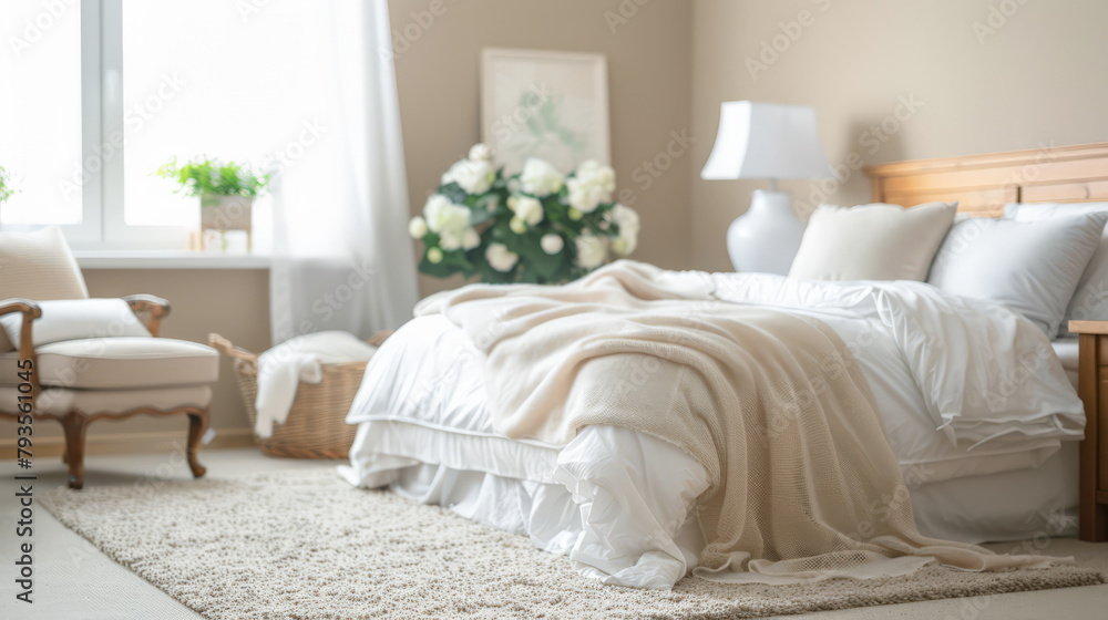 Fototapeta premium Bedroom in neutral tones and minimal decor bathed with natural light coming from a window. Interior design chic bedroom composition.