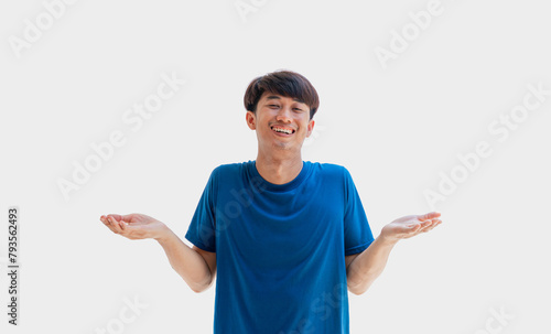 A young Asian man in his 20s wearing a blue t-shirt acts in a relaxed manner isolated on a gray background. A carefree man. concept of positivity photo