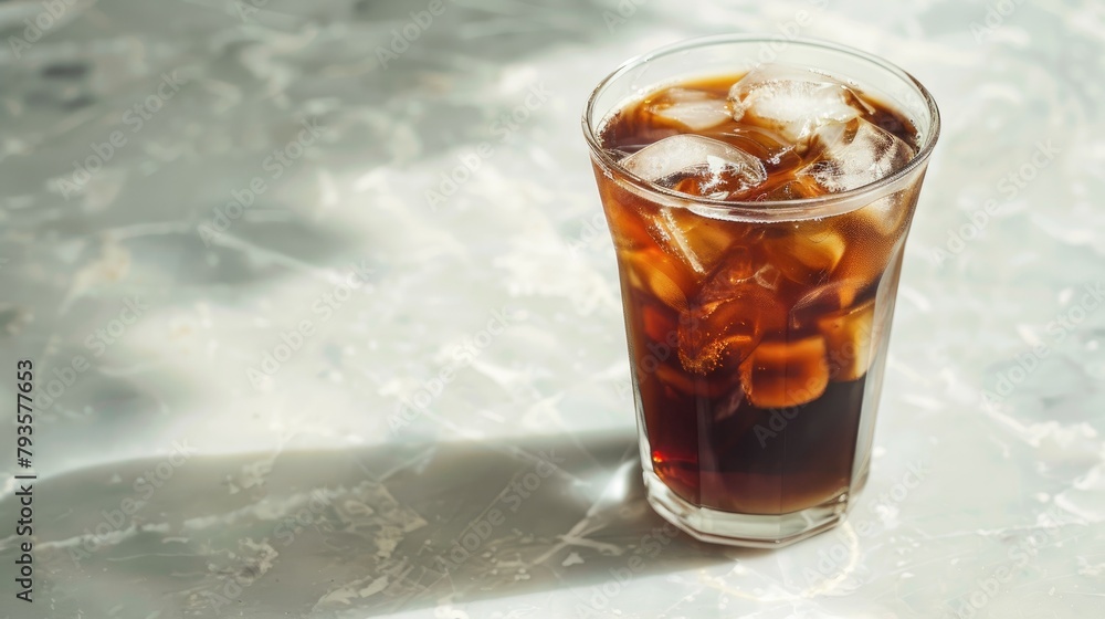 Cold Americano served with ice in a transparent glass Cold Americano served with ice in a transparent glass