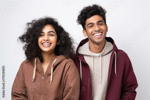 Young indian couple wearing sweatshirt on white background photo