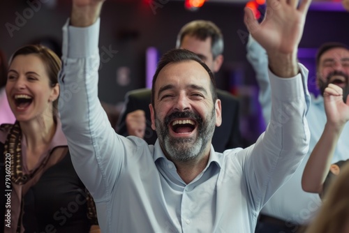 Portrait of happy business people celebrating with arms raised at office party