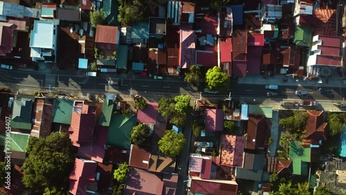 Birds eye aerial above cars driving in middle of houses, in Luzon, Philippines photo