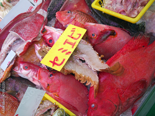 Fresh catch red Tropical fish and halved lobster with price tag on ice for sale on fish market, Makishi Public Market, Naha, Okinawa  photo