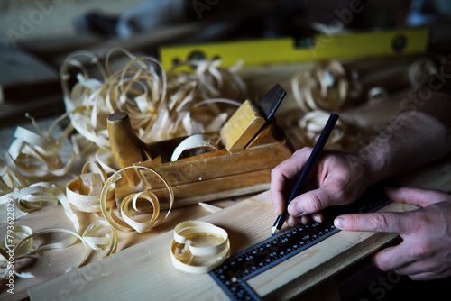 Plane jointer carpenter or joiner tool and wood shavings. Woodworking tools on wooden table. Carpentry workshop photo