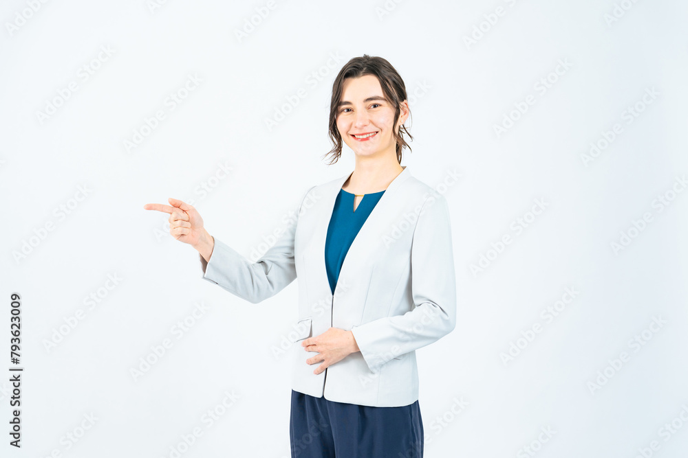 A white woman guiding in front of a white background A white woman guiding in front of a white background