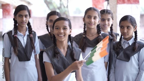 Group of proud schoolgirls students hold indian flag celebrating Independence day, Republic day, patriotism, education, people of india. photo