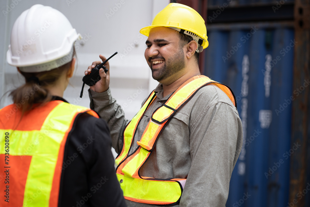 Happy Middle east logistic worker working with caucasian logistic engineer woman at container site Happy Middle east logistic worker working with caucasian logistic engineer woman at container site