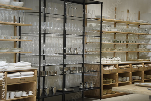 Glasses and dishes are displayed on the shelf