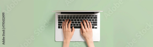 Overhead View of a Man's Hands Typing on a White Laptop