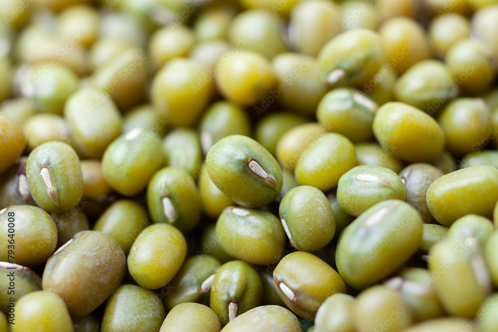 Uncooked, green mung beans background. Dry mung beans grains. Top view. Close-up Uncooked, green mung beans background. Dry mung beans grains. Top view. Close-up