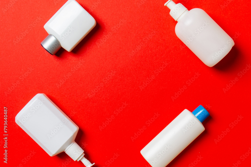 Set of White Cosmetic containers isolated on colored background, top view with copy space. Group of plastic bodycare bottle containers with empty space for you design Set of White Cosmetic containers isolated on colored background, top view with copy space. Group of plastic bodycare bottle containers with empty space for you design