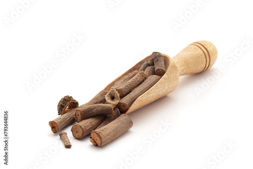 Front view of a wooden scoop filled with Organic Indian sarsaparilla or Anantmool  (Hemidesmus indicus). Isolated on a white background.