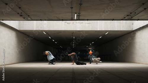 Panorama shot of hipster group dance together while perform b-boy dance. Street dancer team moving to hip hop music while doing freeze pose. Break dance, street dance. Outdoor sport 2024. Sprightly.