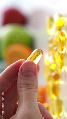 Close-up of a large capsule in a hand. Vitamin D, Fish oil, omega. Daily intake of vitamins and microelements. Biohacking. Healthy lifestyle Health care and control. Replenish vitamin deficiency