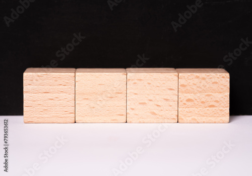 Four empty wooden cubes with place for letters or images