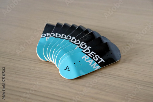 Wooden fingerboard at the ramp on table, close up. Mini skateboard, small skateboard deck
