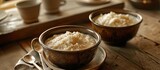 Two bowls of rice pudding on a table, a delicious dessert