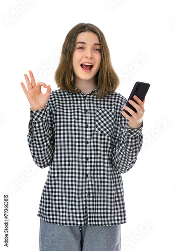 Portrait of pretty eighteen years old womantake selfie and make OK signs, isolated on white background. Studio shot of young woomen holding cell phone and having video call.