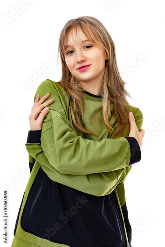 Embrace equity concept in a portrait of fourteen year old girl, looks with happy expression, isolated on white background. Pretty caucasian girl hugging herself, smiling and posing in studio.
