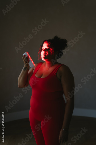 Black woman using infrared red light therapy skincare photo