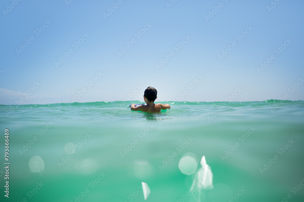 custom made wallpaper toronto digitalYoung boy swimming in sun-drenched emerald ocean