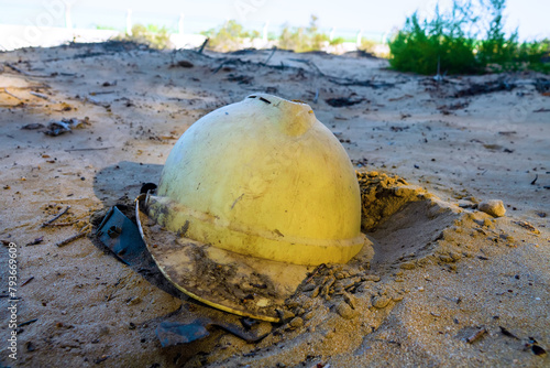 Hastily abandoned construction helmet in the sand