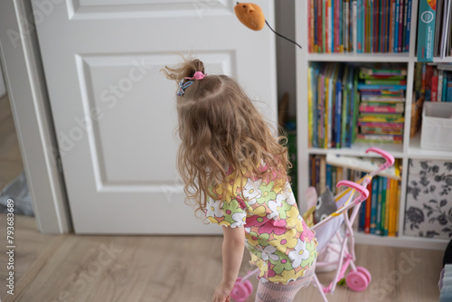 little girl having fun at home, movement and hair © skypictom