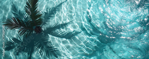Shadow of a palm tree falls on the turqoise water in the pool top view background copy space for text. photo