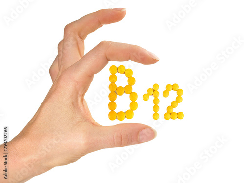 Vitamin B Pills isolated - B12 on white background with Woman Hand