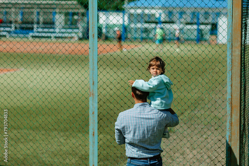 The father and the child came to watch the athletes train and prepare for the competition.