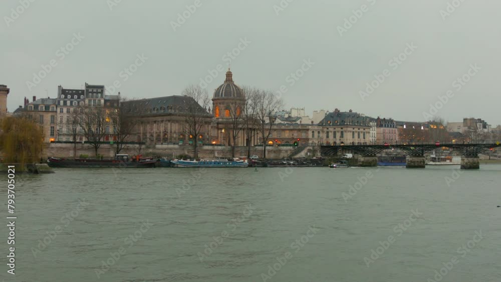 Wide angle view of Pont Des Arts (pedestrian bridge) with waterfront in Paris, France. Wide angle view of Pont Des Arts (pedestrian bridge) with waterfront in Paris, France.