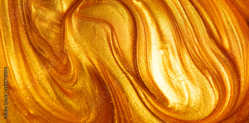 Beautiful abstract golden liquid paint background, beauty gold backdrop texture. Metallic gold paint, art design. Yellow shimmering surface close-up. Golden bright glitter texture, macro shot  © Subbotina Anna